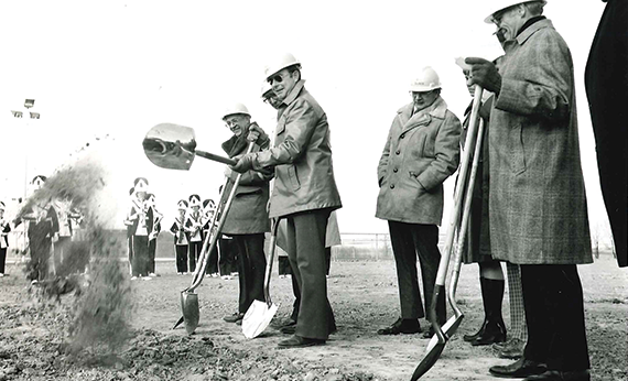 Men with shovels and hardhats at groundbreaking ceremony 